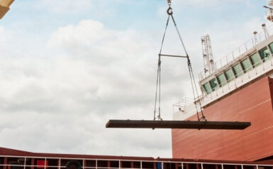 A ship loading cargo with a crane