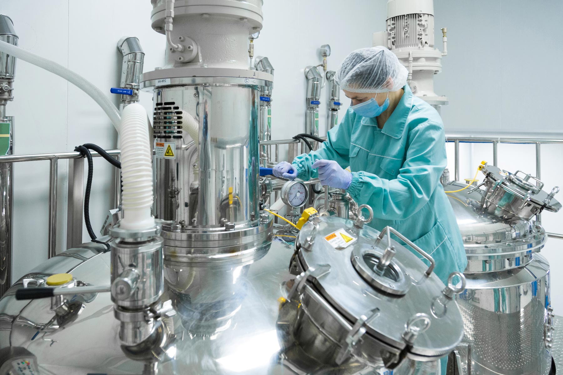 Woman in lab coat working with machines