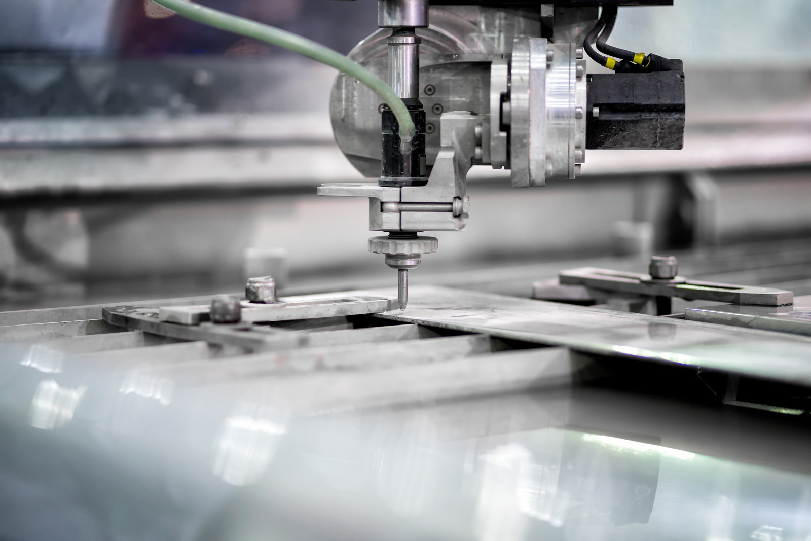 A close up of the tip of a waterjet cutter for steel