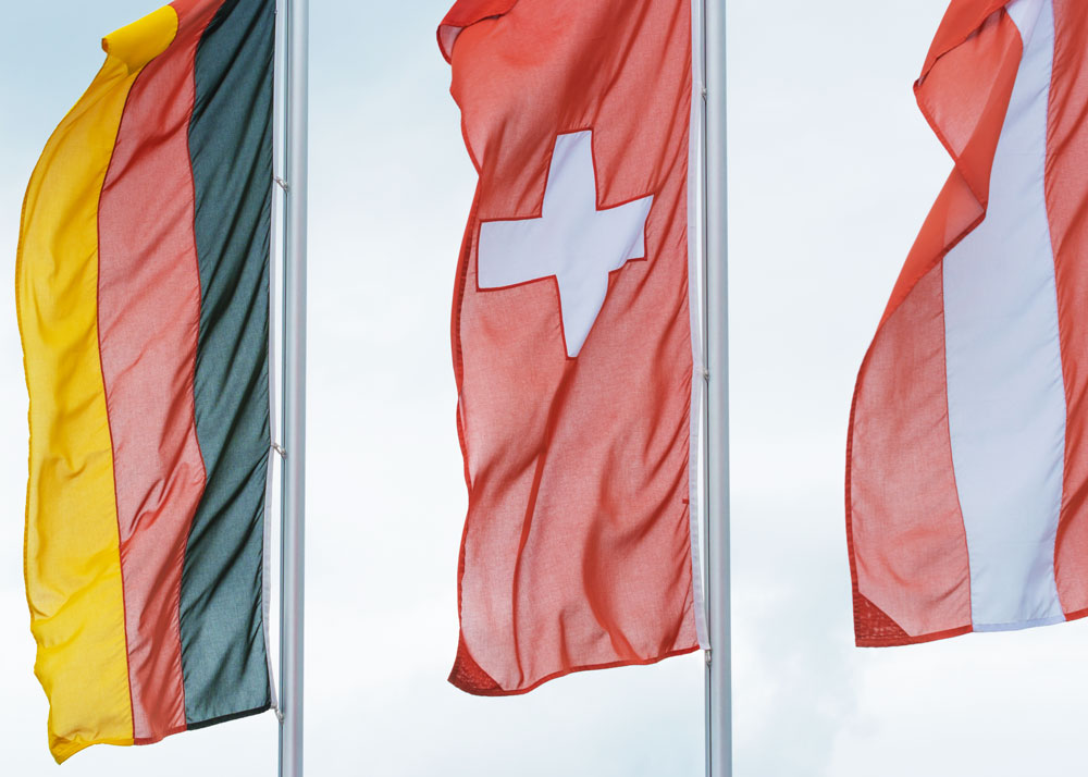 Austrian German and Swiss flag waving in the wind